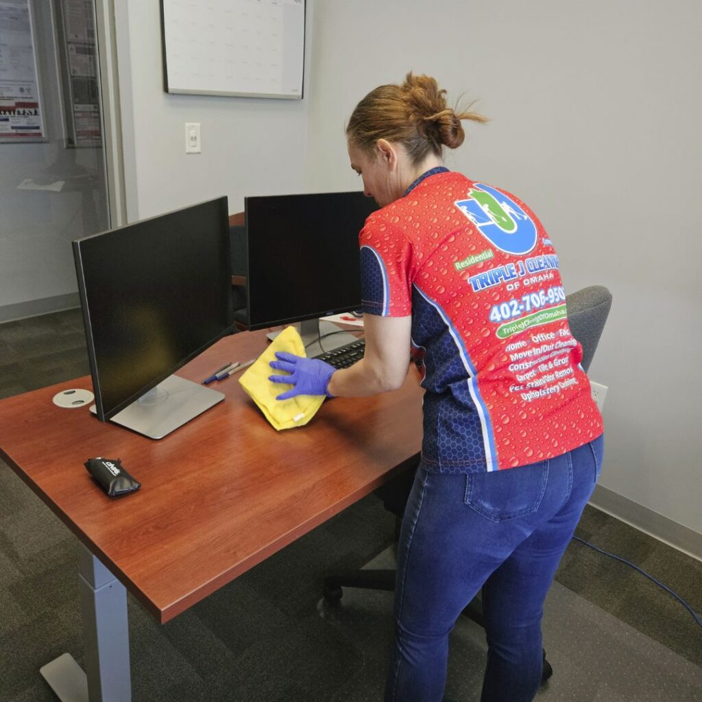 Office cleaning services Omaha – Triple J Cleaning of Omaha team disinfecting a professional workspace for healthy employees.