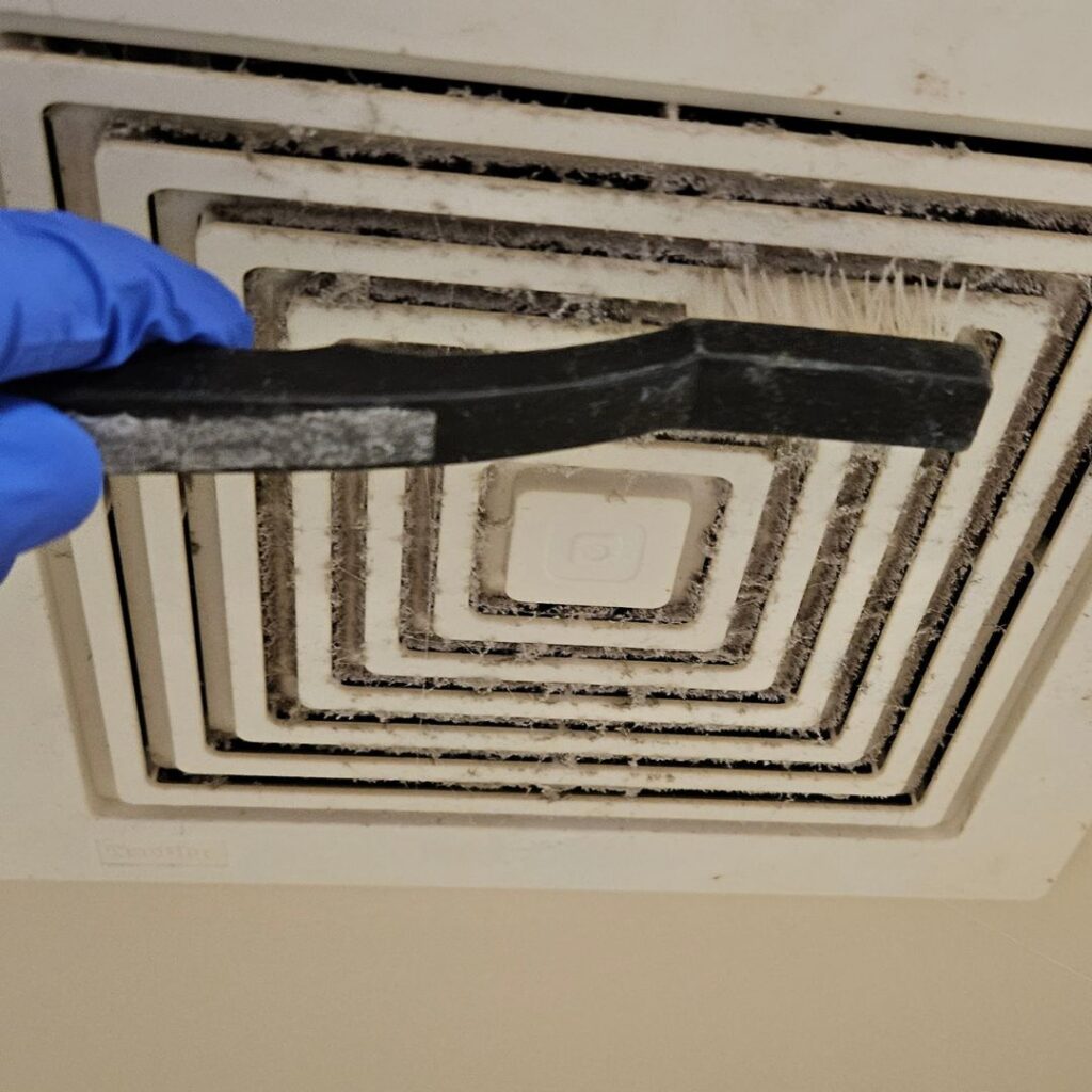 Triple J Cleaning of Omaha team performing detailed vent cleaning during deep house cleaning service in Omaha Nebraska.