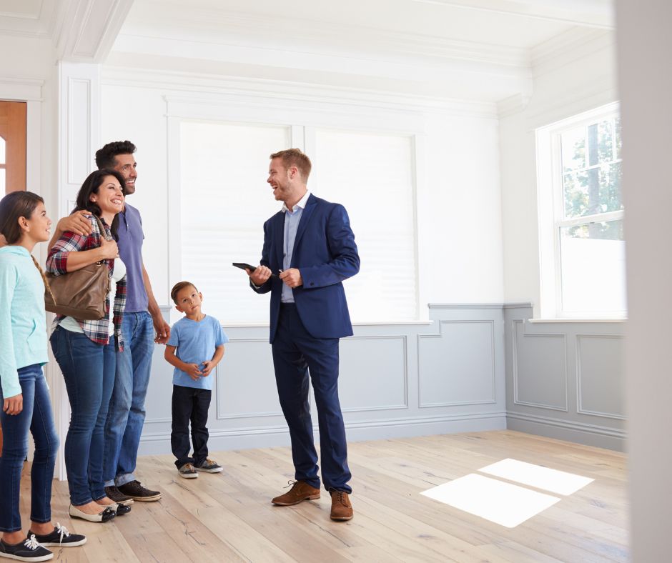 Happy Omaha family with realtor inside a clean, empty home after professional move-out cleaning by Triple J Cleaning of Omaha.