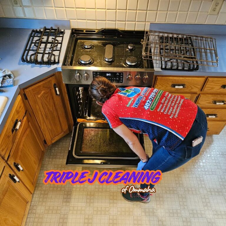 A professional cleaner from Triple J Cleaning of Omaha performs an oven deep clean in a local kitchen. We specialize in residential cleaning services, including move-out cleaning in Bellevue NE and appliance cleaning.