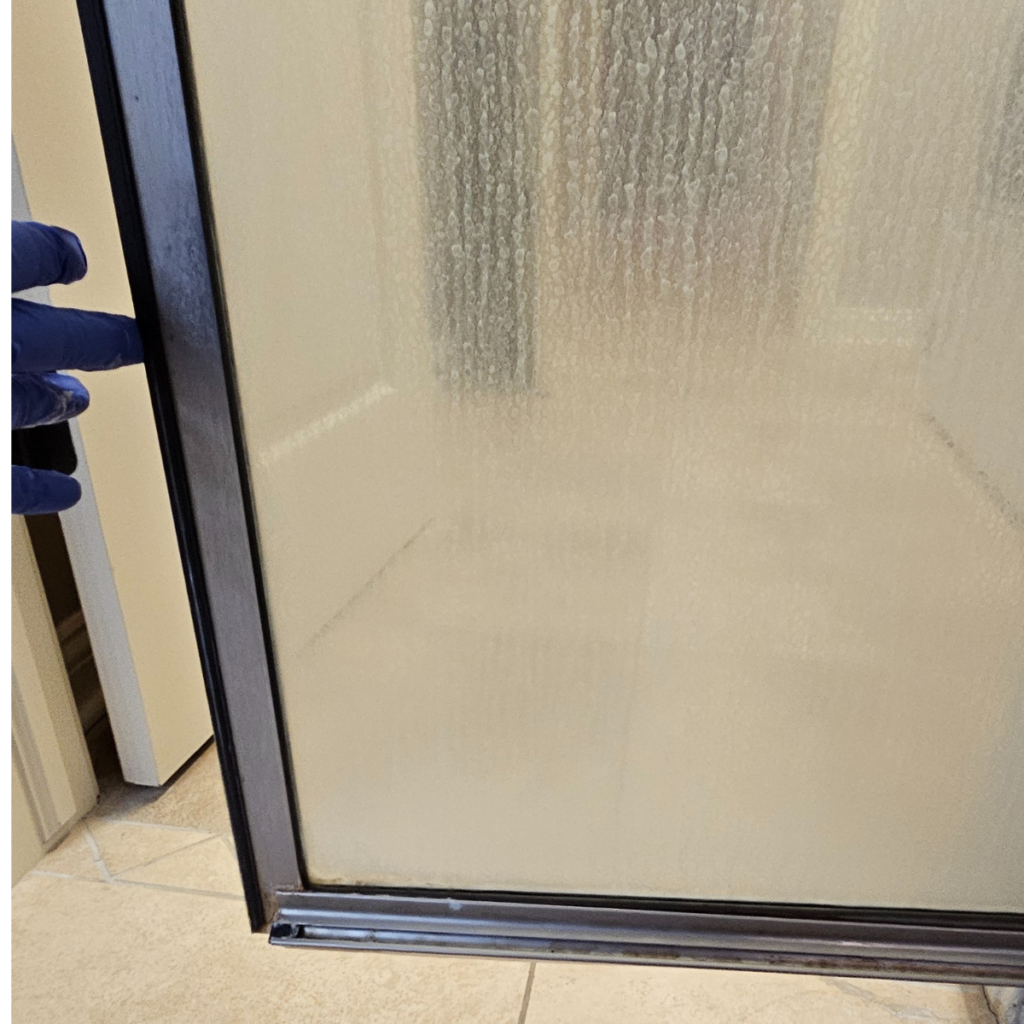 foggy shower glass hard water stains before cleaning Omaha NE bathroom deep cleaning hard water buildup removal Omaha